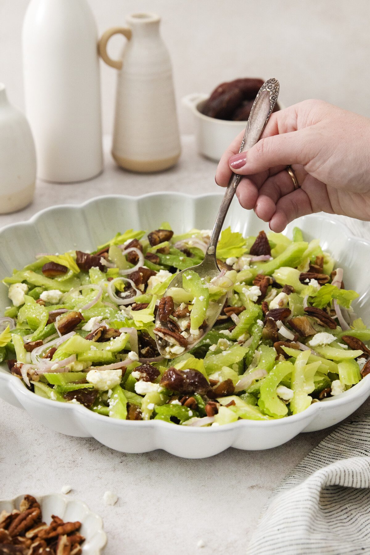 hand holding spoon digging into salad