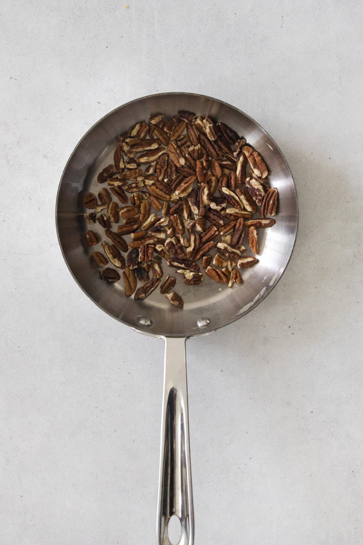 pecans toasting in a pan