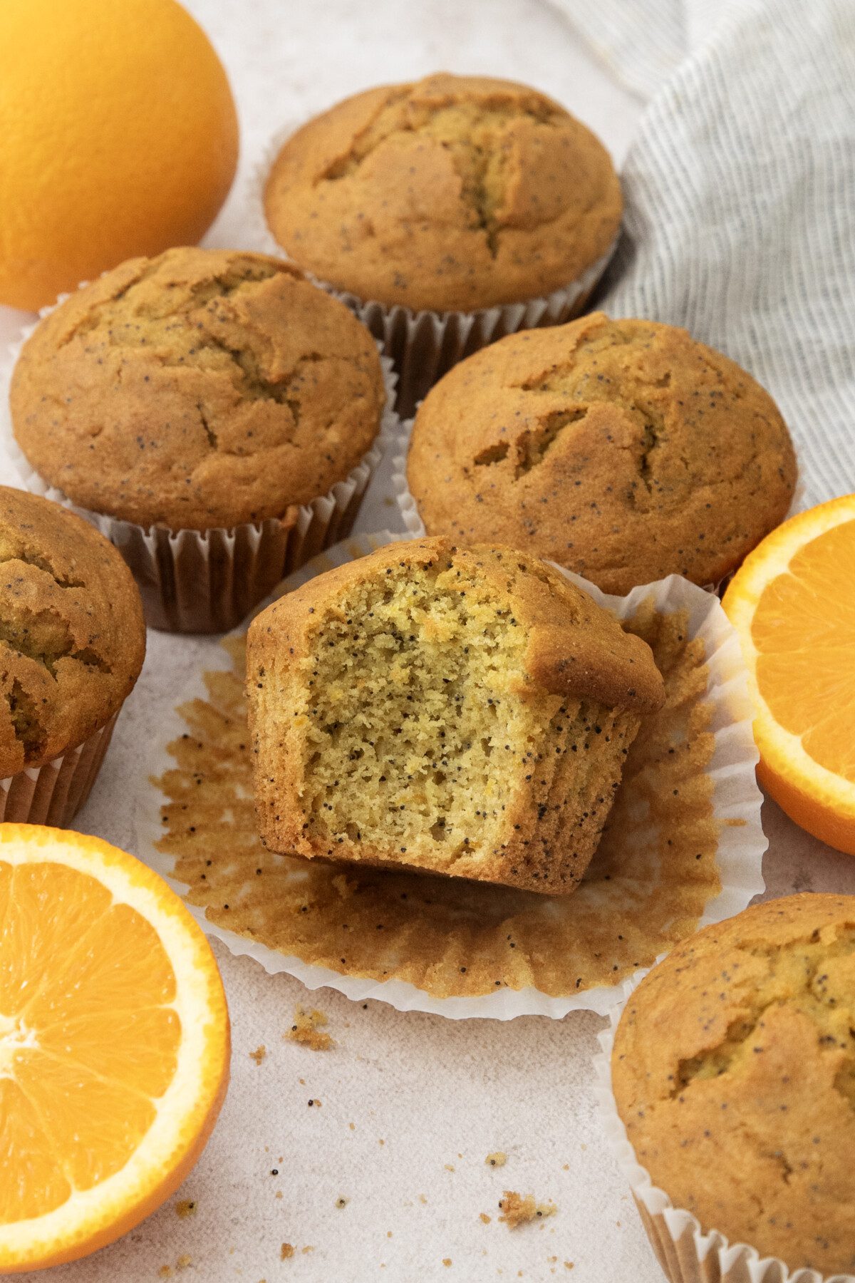 a group of muffins, one with a bite out of it