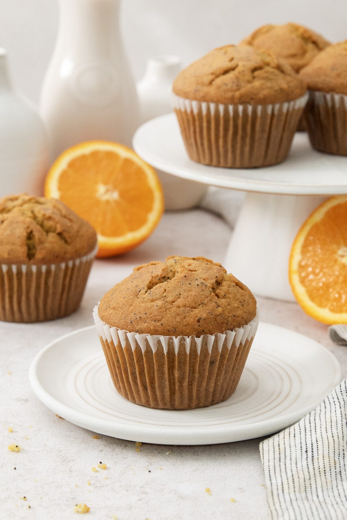 close up of orange poppyseed bakery-style muffin