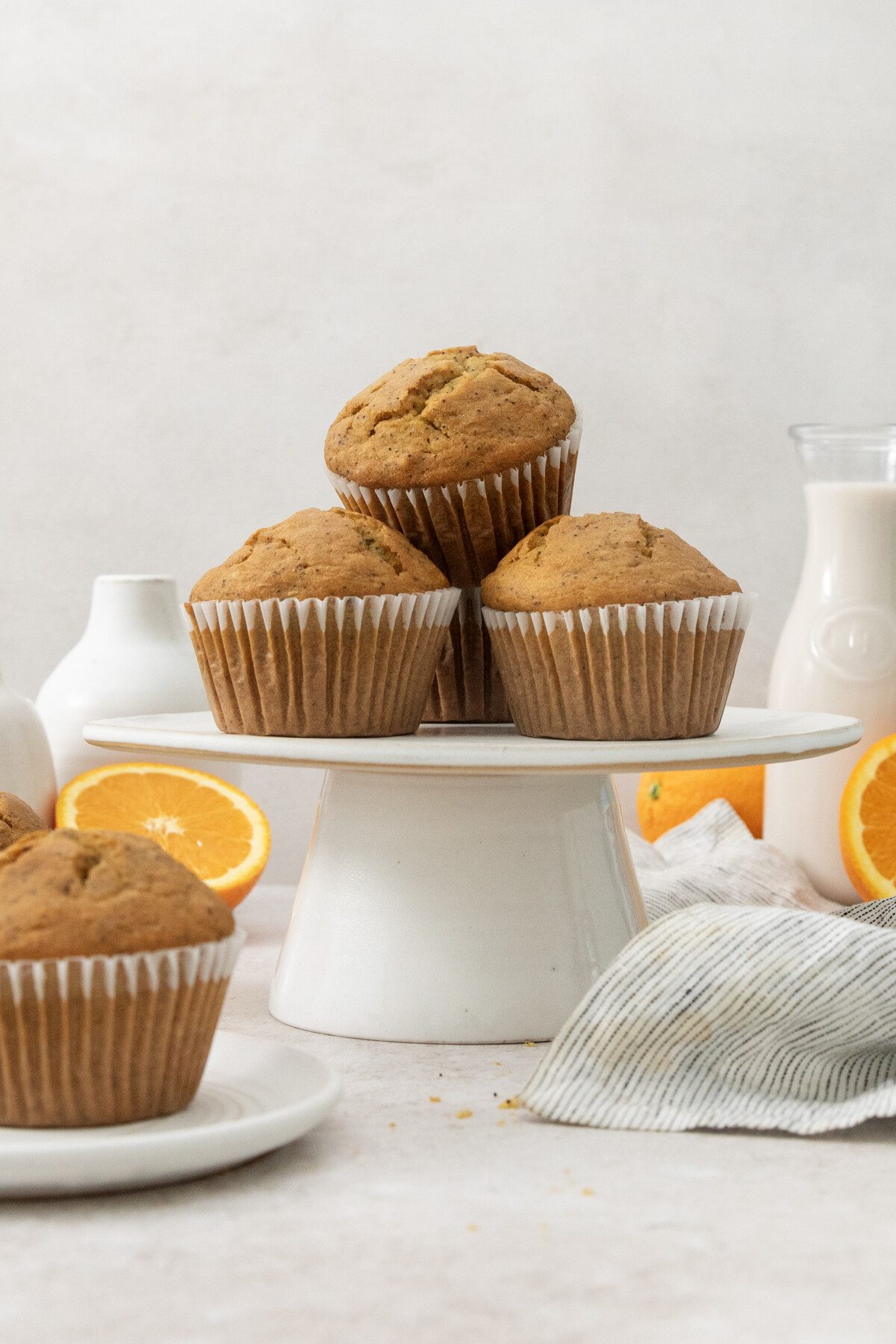 a stack of bakery-style orange poppyseed muffins