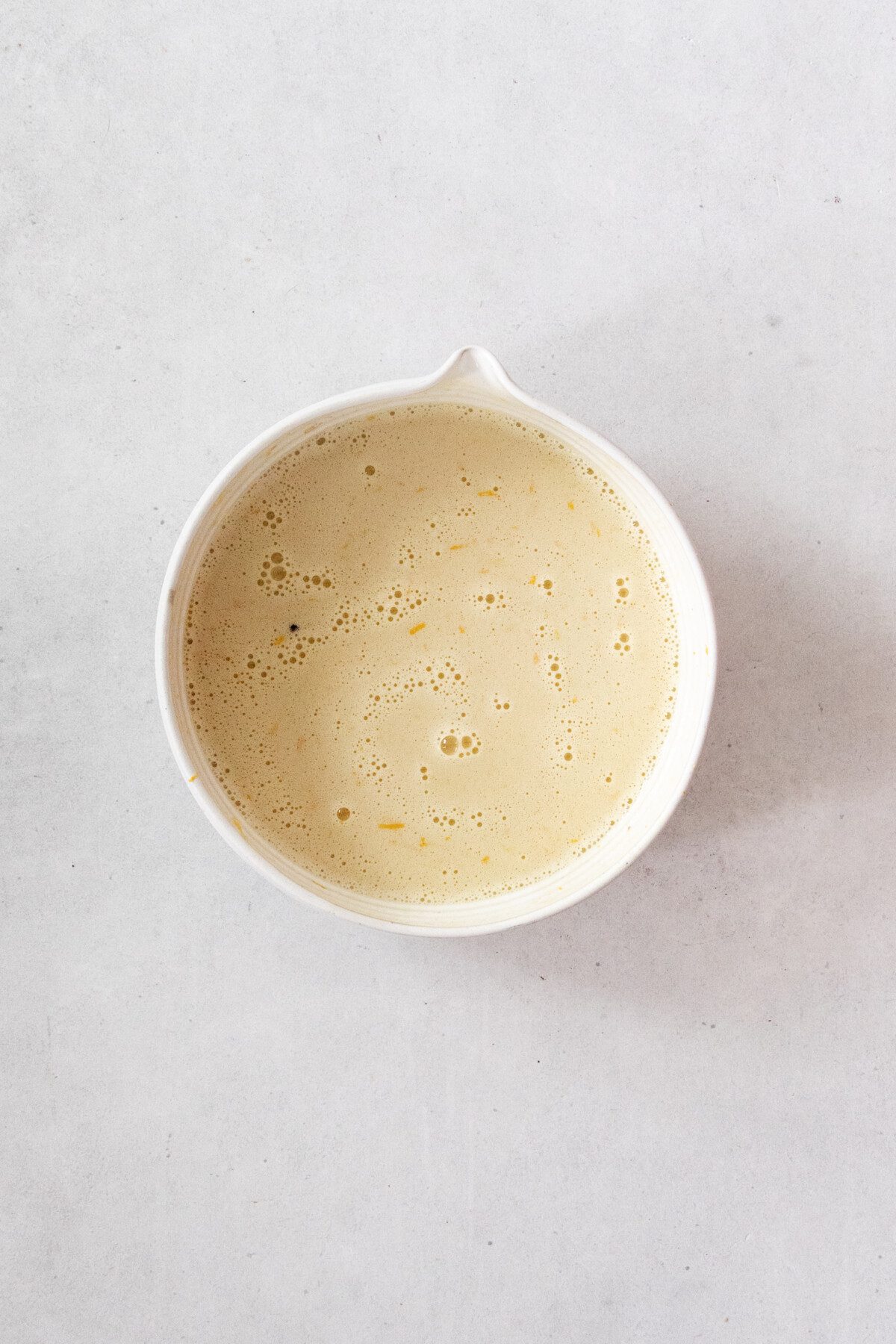 wet muffin ingredients in a ceramic bowl