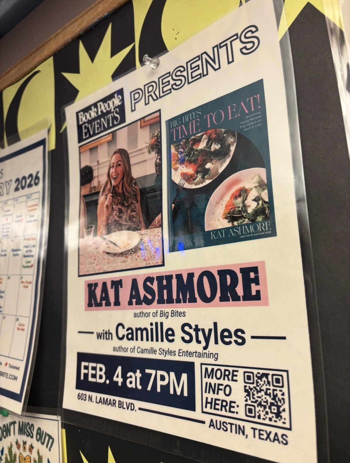 A poster on a bulletin board promotes a Book People event featuring Kat Ashmore and Camille Styles on February 4 at 7 PM in Austin, Texas, with photos of Kat and her cookbook Big Bites: Time to Eat.